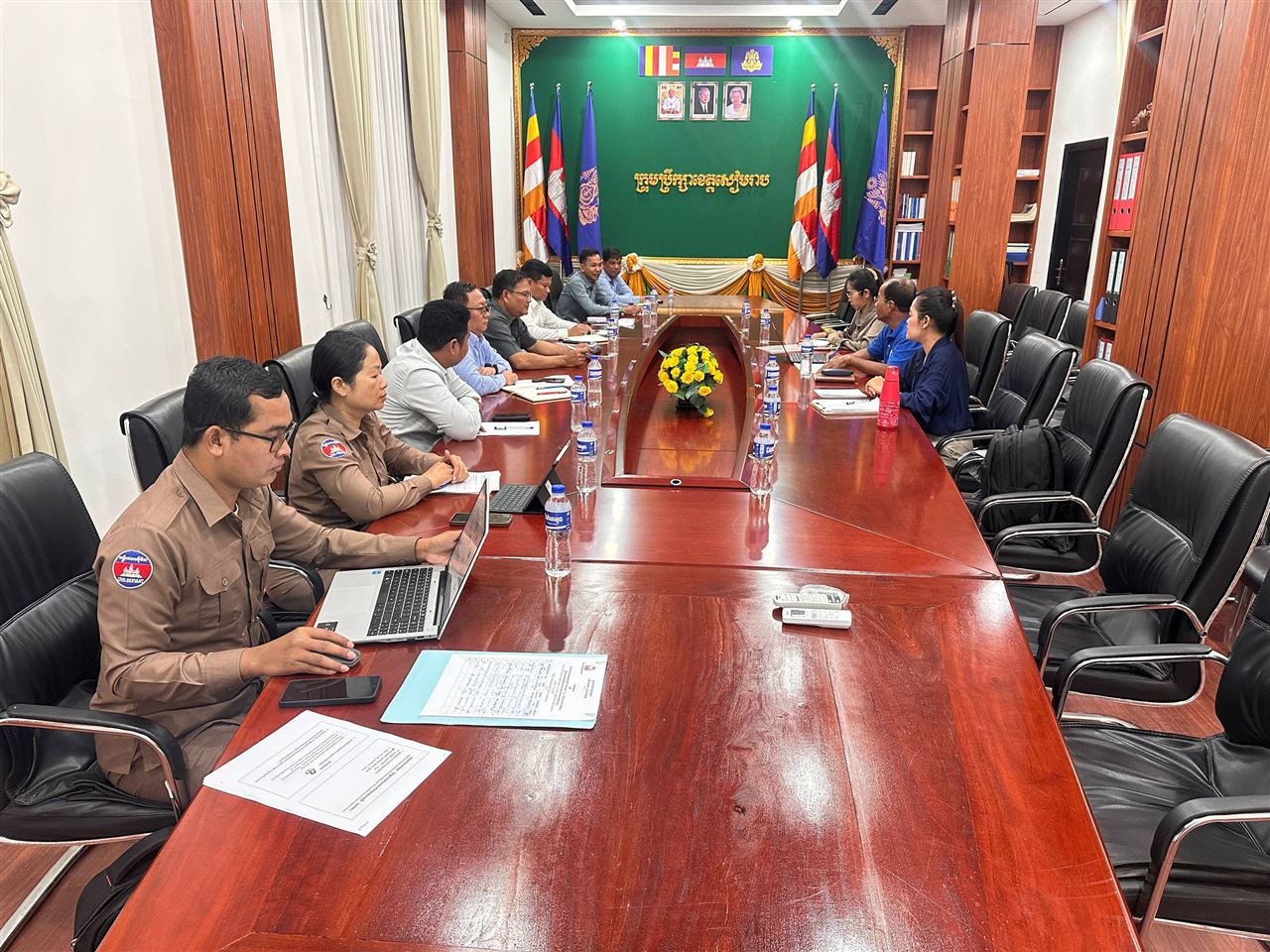 Provincial officials and the pilot team seated along a long meeting table in the Siem Reap Provincial Council meeting room